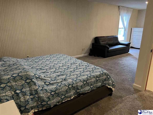 bedroom with wallpapered walls, carpet flooring, and baseboards