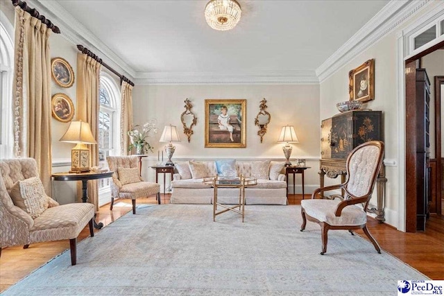 living area featuring crown molding and wood finished floors