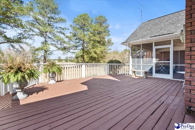 wooden terrace featuring a sunroom