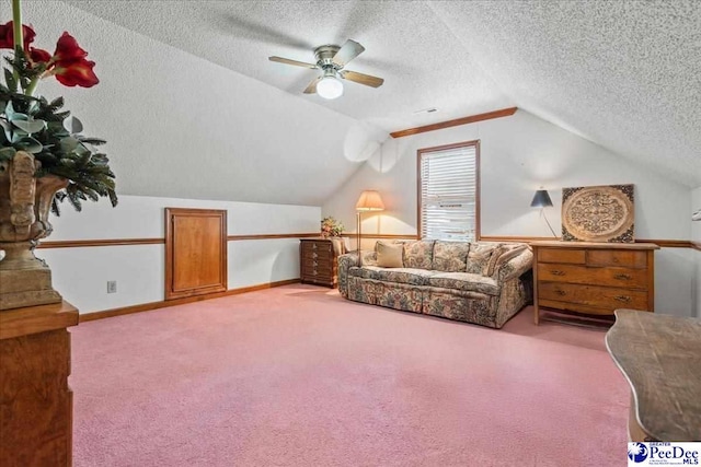 living area with lofted ceiling, a textured ceiling, carpet flooring, baseboards, and ceiling fan