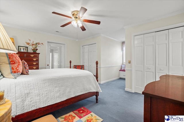 carpeted bedroom with visible vents, two closets, ornamental molding, baseboards, and ceiling fan