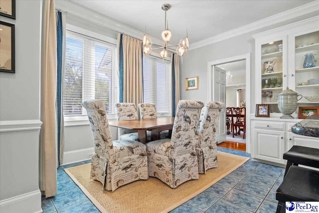 dining space with tile patterned floors, baseboards, an inviting chandelier, and crown molding