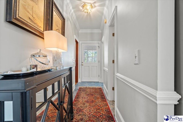 doorway to outside with baseboards and ornamental molding