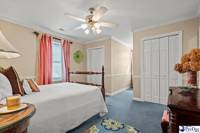 carpeted bedroom featuring visible vents, multiple closets, a ceiling fan, crown molding, and baseboards