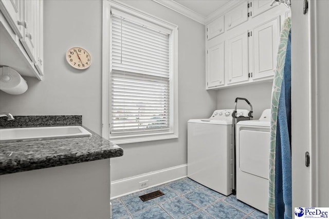 laundry area with independent washer and dryer, ornamental molding, a sink, cabinet space, and baseboards