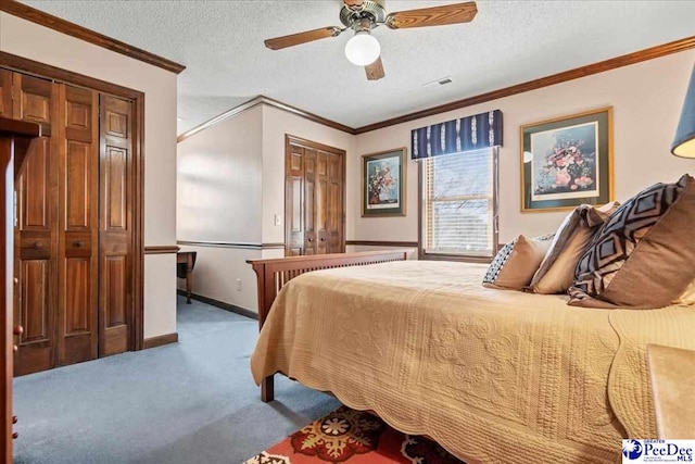 bedroom featuring baseboards, carpet floors, ceiling fan, ornamental molding, and a textured ceiling