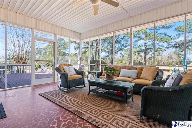 sunroom / solarium with a ceiling fan