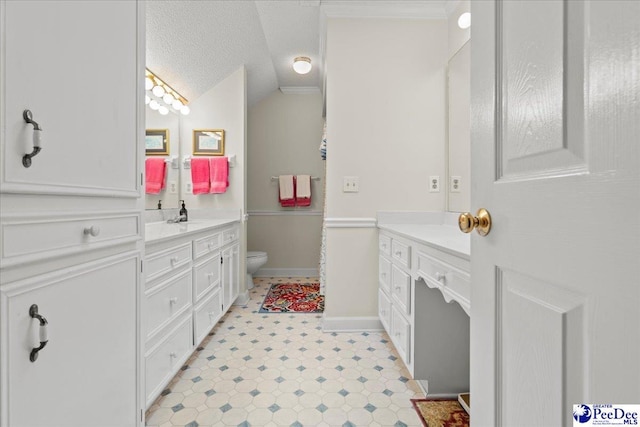 bathroom featuring vanity, lofted ceiling, toilet, and a textured ceiling