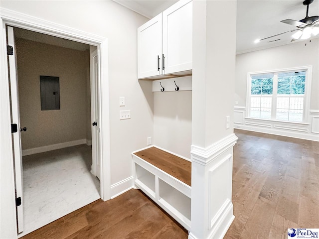 mudroom featuring ornamental molding, dark wood-type flooring, electric panel, and ceiling fan