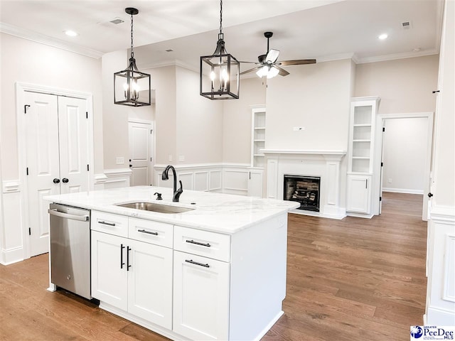 kitchen with dishwasher, pendant lighting, sink, white cabinetry, and a kitchen island with sink