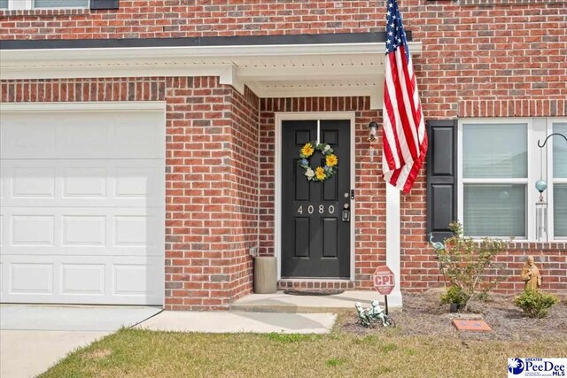 4080 Lake Russell Dr, Florence, SC 29501 - property entrance with brick siding, driveway, and a garage