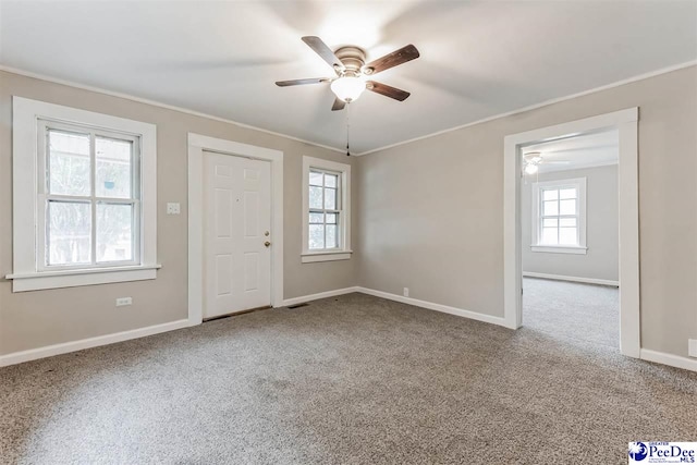 carpeted empty room featuring ceiling fan and ornamental molding