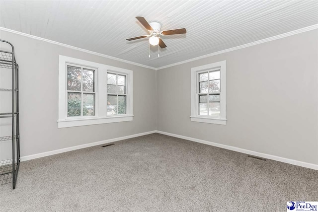 carpeted spare room with ornamental molding and ceiling fan