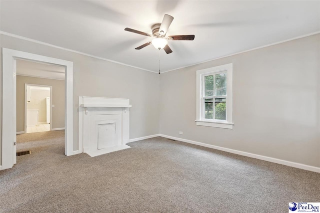 carpeted empty room with crown molding and ceiling fan