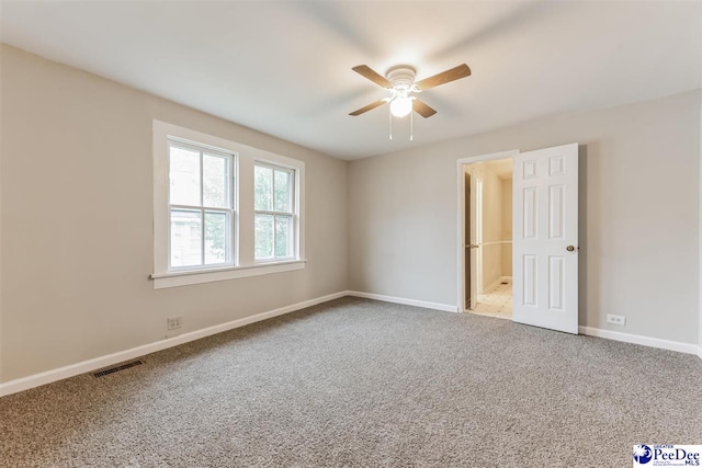 carpeted empty room featuring ceiling fan