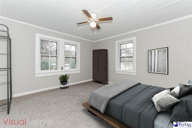 carpeted bedroom featuring crown molding and ceiling fan