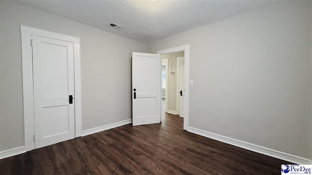 empty room with dark wood-type flooring