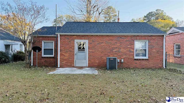 back of property featuring central AC, a yard, and a patio