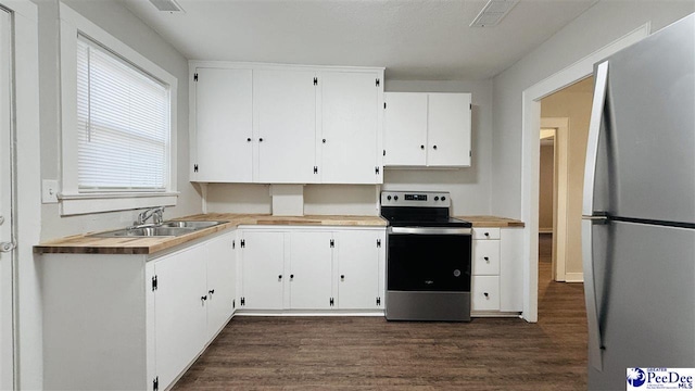 kitchen featuring white cabinetry, sink, stainless steel appliances, and dark hardwood / wood-style floors