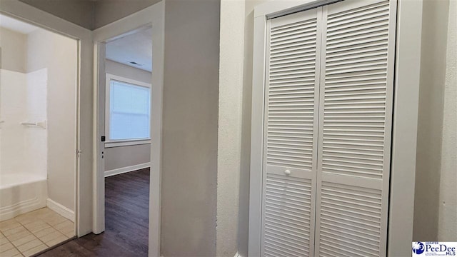 hallway with dark hardwood / wood-style flooring