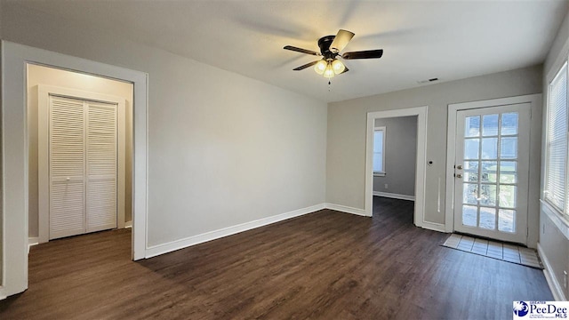 interior space with ceiling fan and dark hardwood / wood-style floors