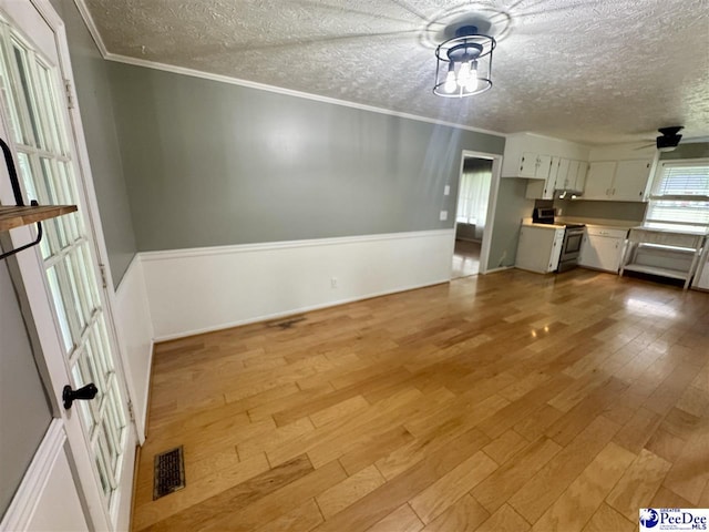188 Chatham Trace Cir, Cheraw, SC 29520 - unfurnished living room with a textured ceiling, light wood-type flooring, ornamental molding, and ceiling fan