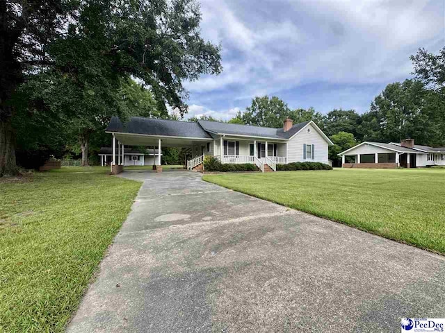 188 Chatham Trace Cir, Cheraw, SC 29520 - view of front of home featuring a porch, driveway, a front yard, a carport, and a chimney