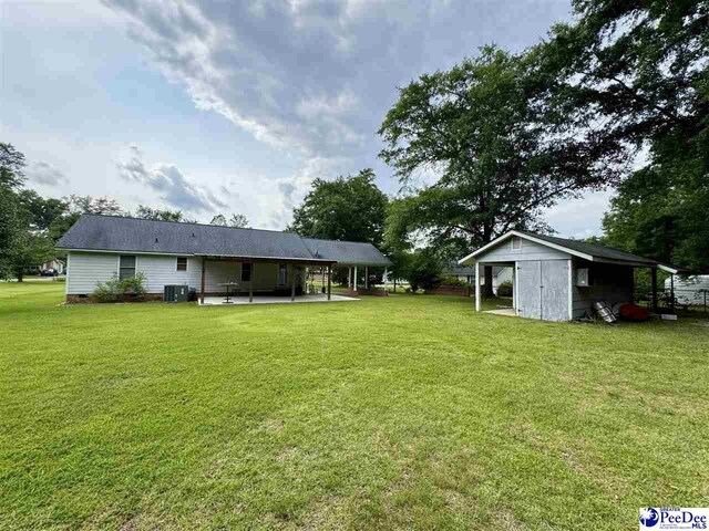 188 Chatham Trace Cir, Cheraw, SC 29520 - rear view of house with a patio area, a lawn, a shed, and crawl space