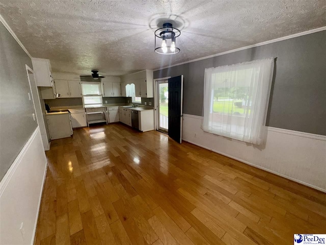 188 Chatham Trace Cir, Cheraw, SC 29520 - kitchen featuring a textured ceiling, stainless steel dishwasher, crown molding, white cabinetry, and wood finished floors