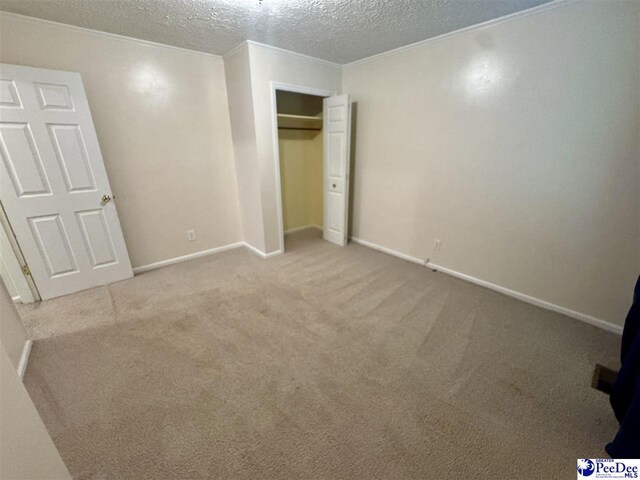188 Chatham Trace Cir, Cheraw, SC 29520 - unfurnished bedroom featuring a textured ceiling, carpet flooring, and a closet