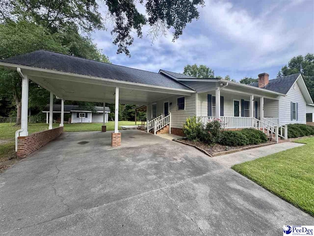188 Chatham Trace Cir, Cheraw, SC 29520 - view of front of house featuring driveway, a front lawn, a carport, and covered porch