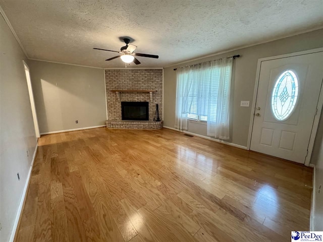 188 Chatham Trace Cir, Cheraw, SC 29520 - unfurnished living room with a ceiling fan, a textured ceiling, wood finished floors, plenty of natural light, and ornamental molding