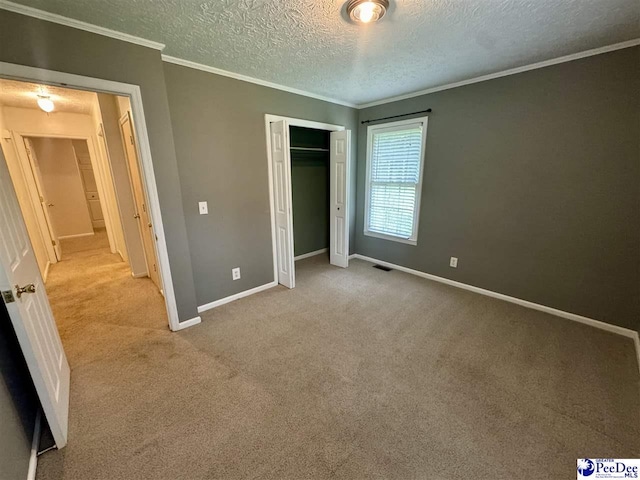 188 Chatham Trace Cir, Cheraw, SC 29520 - unfurnished bedroom with carpet flooring, crown molding, a textured ceiling, and a closet