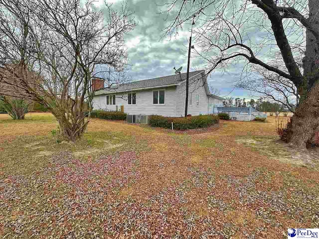 view of side of home with a lawn