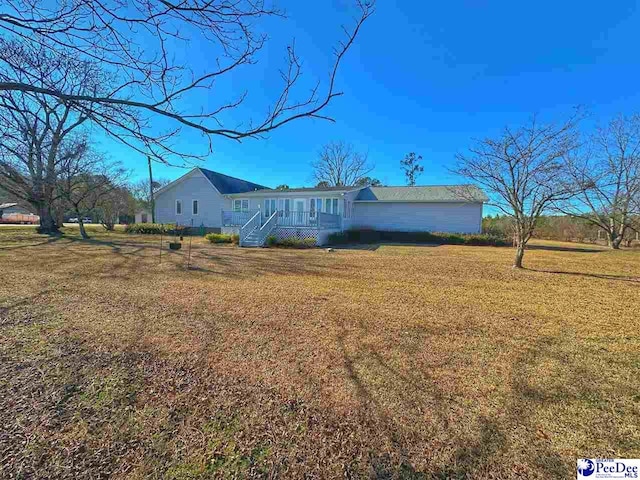 back of property featuring a lawn