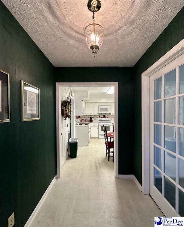 hallway with a textured ceiling