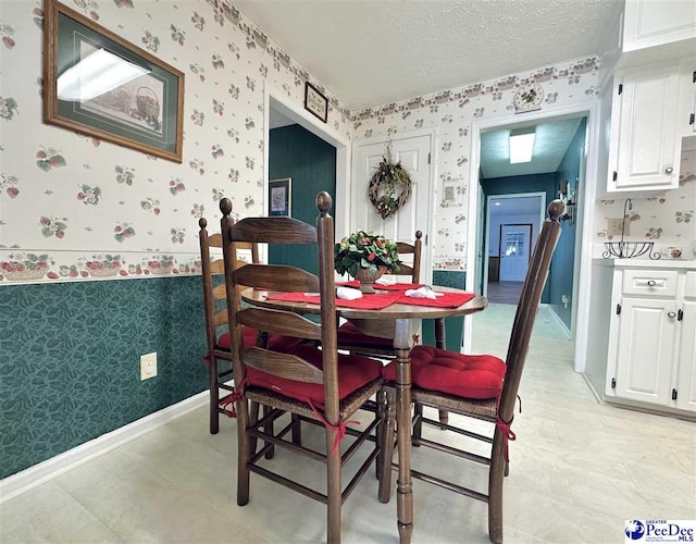 dining space with a textured ceiling