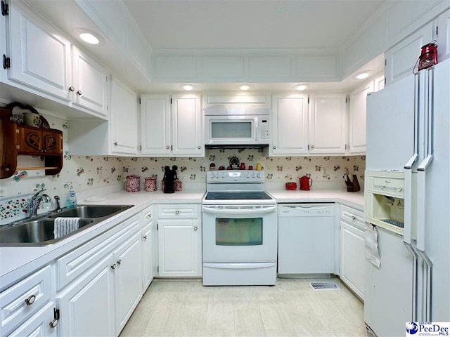 kitchen featuring sink, white cabinetry, ornamental molding, white appliances, and decorative backsplash