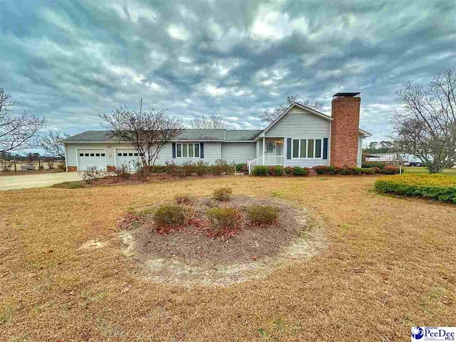 single story home with a garage and a front yard