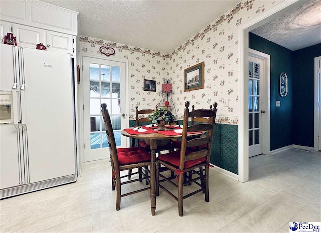 dining area featuring a textured ceiling