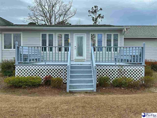 back of property with a wooden deck