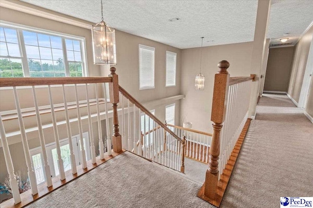 2770 Gray Dr, Darlington, SC 29532 - staircase with carpet flooring, a textured ceiling, and a chandelier