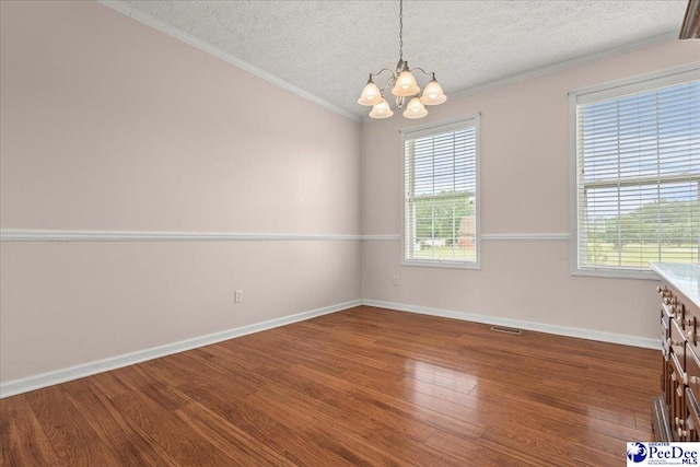 2770 Gray Dr, Darlington, SC 29532 - unfurnished dining area with a chandelier, a textured ceiling, wood finished floors, and ornamental molding