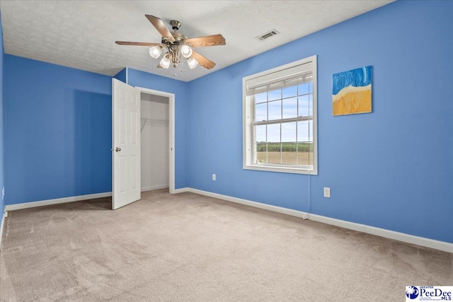 2770 Gray Dr, Darlington, SC 29532 - unfurnished bedroom with carpet, a textured ceiling, a ceiling fan, and a closet