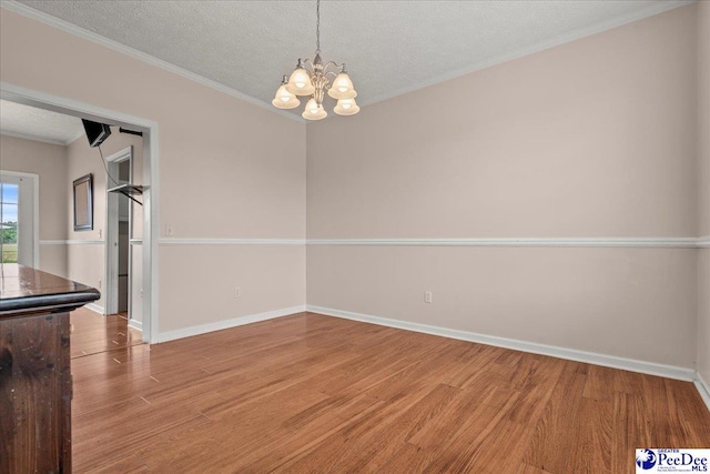 2770 Gray Dr, Darlington, SC 29532 - unfurnished dining area with light wood finished floors, a textured ceiling, a chandelier, and ornamental molding