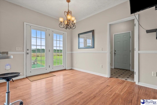 2770 Gray Dr, Darlington, SC 29532 - unfurnished dining area with a chandelier, light wood finished floors, ornamental molding, and a textured ceiling