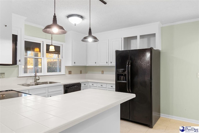 kitchen featuring pendant lighting, white cabinetry, tile counters, and black appliances