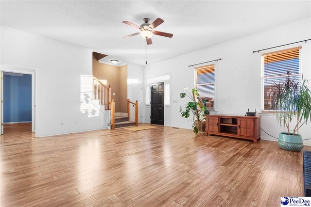 unfurnished living room with ceiling fan and light hardwood / wood-style floors