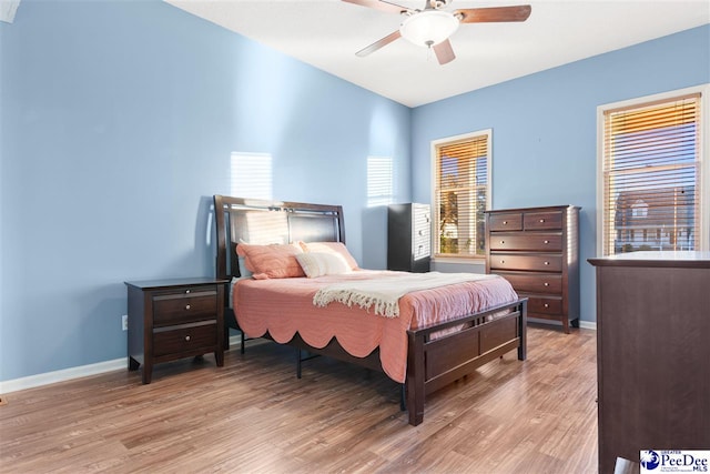 bedroom with ceiling fan and light wood-type flooring