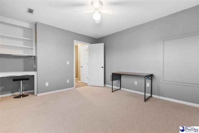 interior space featuring a textured ceiling and ceiling fan